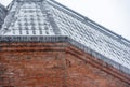 The roof top covered with ice and snow with icicles