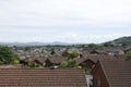 Roof tops of Abergele village in Britain with surrounding countryside, mountains, hills and blue sky and clouds 1 of 2 Royalty Free Stock Photo
