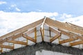 Roof trusses not covered with ceramic tiles on a single-family house under construction, visible roof elements and rafters. Royalty Free Stock Photo