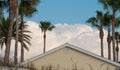 Roof, white clouds, palm trees Royalty Free Stock Photo