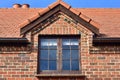 Roof window of red brick cottage Royalty Free Stock Photo