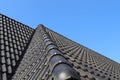 Roof window in velux style with black roof tiles