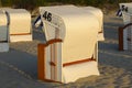 Roofed beach chairs during sunset