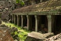 Roofed colonnade ending in pile of rubble