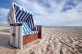 roofed wicker beach chair on baltic beach Royalty Free Stock Photo