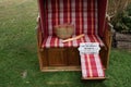 A roofed wicker beach chair for the perfect moment with a bottle of wine and a baguette