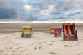 Roofed wicker beach chairs at a beach at Langeoog at the north sea in the evening Royalty Free Stock Photo