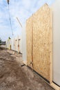 Roofer builder worker with crane installing structural Insulated Panels SIP. Building new frame energy-efficient house. Royalty Free Stock Photo