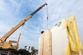 Roofer builder worker with crane installing structural Insulated Panels SIP. Building new frame energy-efficient house. Royalty Free Stock Photo