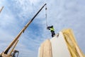 Roofer builder worker with crane installing structural Insulated Panels SIP. Building new frame energy-efficient house. Royalty Free Stock Photo