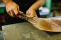 Roofer builder worker finishing folding a metal sheet using metal shears Royalty Free Stock Photo