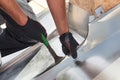 Roofer builder worker finishing folding a metal sheet using special pliers with a large flat grip. Royalty Free Stock Photo