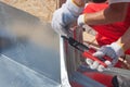 Roofer builder worker finishing folding a metal sheet using special pliers with a large flat grip. Royalty Free Stock Photo