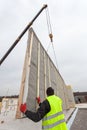 Roofer builder workers with crane installing structural Insulated Panels SIP. Building new frame energy-efficient house.