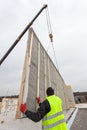 Roofer builder workers with crane installing structural Insulated Panels SIP. Building new frame energy-efficient house. Royalty Free Stock Photo