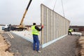 Roofer builder workers with crane installing structural Insulated Panels SIP. Building new frame energy-efficient house.