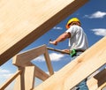 Roofer carpenter working on roof on construction site Royalty Free Stock Photo