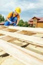 Roofer carpenter works on roof Royalty Free Stock Photo