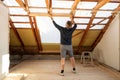 Roofer is changing the rafter for a bigger window in the attic