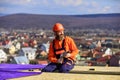 Roofer constructing roof. Man roofing surface. Install partially overlapping layers of material over roof insulation