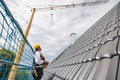 roofer on construction site operating crane Royalty Free Stock Photo