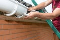 Roofer contractor installing and repair rain gutter pipeline Royalty Free Stock Photo