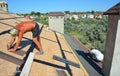 Roofer contractors laying and installing asphalt shingles. Roof asphalt shingles installation with two roofers. Roofing