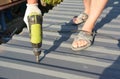 Roofer with crew gun installing metal roof tiles. Roofing construction with roofing contractor laying metal roof sheets Royalty Free Stock Photo