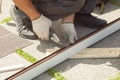 Roofer cuts profile on metal scissors. Royalty Free Stock Photo