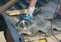 Roofer cutting asbestos sheet on the house rooftop Royalty Free Stock Photo