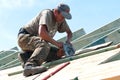 Roofer with Electric Saw