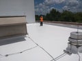 Roofer inspecting a commercial flat roof, EPDM Roofing Royalty Free Stock Photo