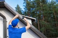 Roofer installing metal drip edge profile on the house roof Royalty Free Stock Photo