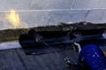Roofer installing rolls of bituminous waterproofing