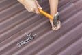 Roofer installs asphalt shingles Ondulin, roof repair