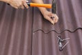 Roofer installs asphalt shingles Ondulin, roof repair