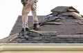 Roofer removing roof shingles with roof shingle remover Royalty Free Stock Photo