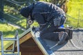 Roofer repairing the metal facing after storm