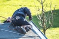 Roofer repairing the metal facing with tin after storm