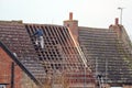 Roofer repairing roof.