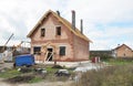 Roofer on the Roof and Lay Asphalt Roofing Shingles. Building House Construction Site.