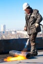 Roofer worker installing a roll of roofing felt Royalty Free Stock Photo