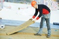 Roofer worker installing roof insulation material Royalty Free Stock Photo