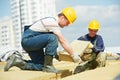 Roofer worker installing roof insulation material Royalty Free Stock Photo