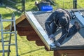 Roofer worker using battery-powered gun