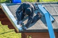 Roofer worker using battery-powered gun