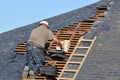 Roofer worker working on the roof of a house