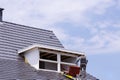 Roofer Working On A New Dormer Construction on the Roof