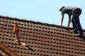 Roofer is working on a roof