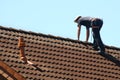 Roofer is working on a roof